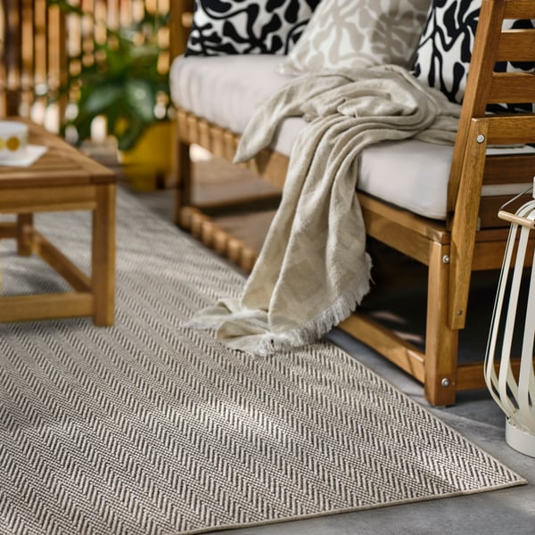 A beige LYDERSHOLM rug flatwoven, in/outdoor outside