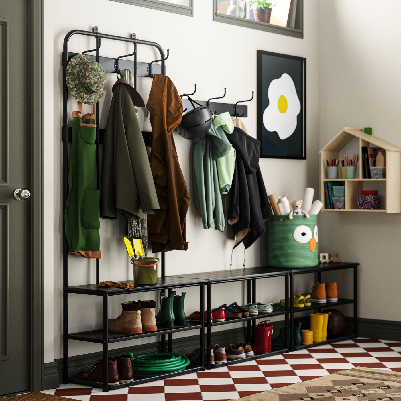 A black PINNIG rack with 3 hooks in the hallway