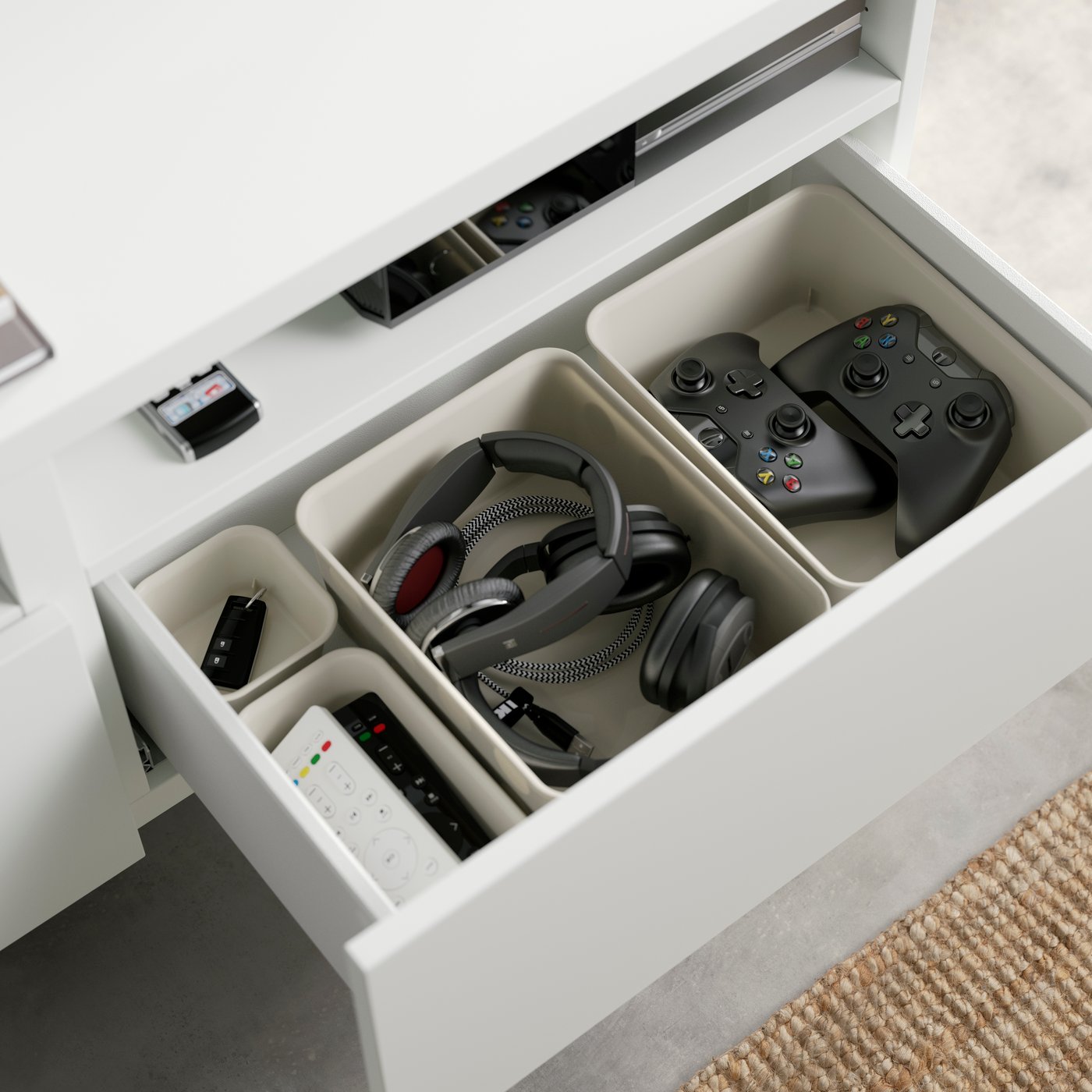 NOJIG internal storage organisers in a BESTA drawer showing gaming devices sorted and stored neatly.