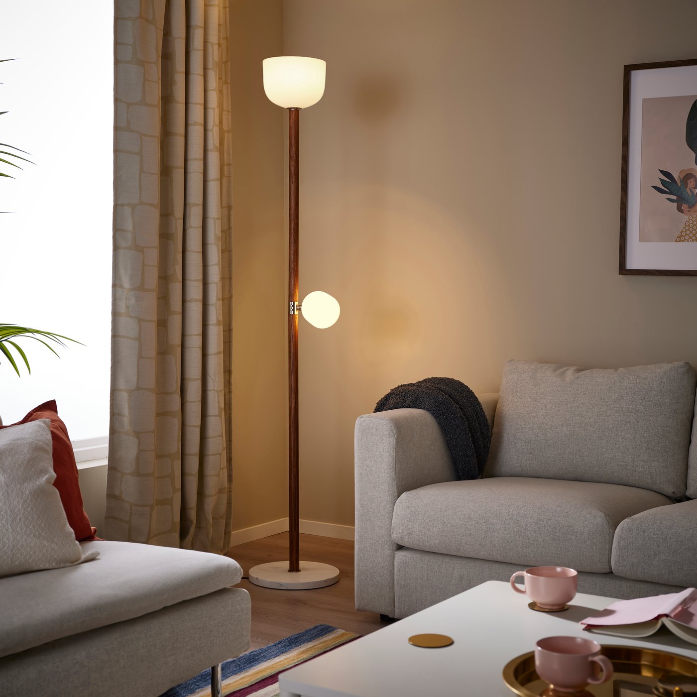 An opal white glass/dark brown oak MOSSPLYM floor uplighter/reading lamp in the living room