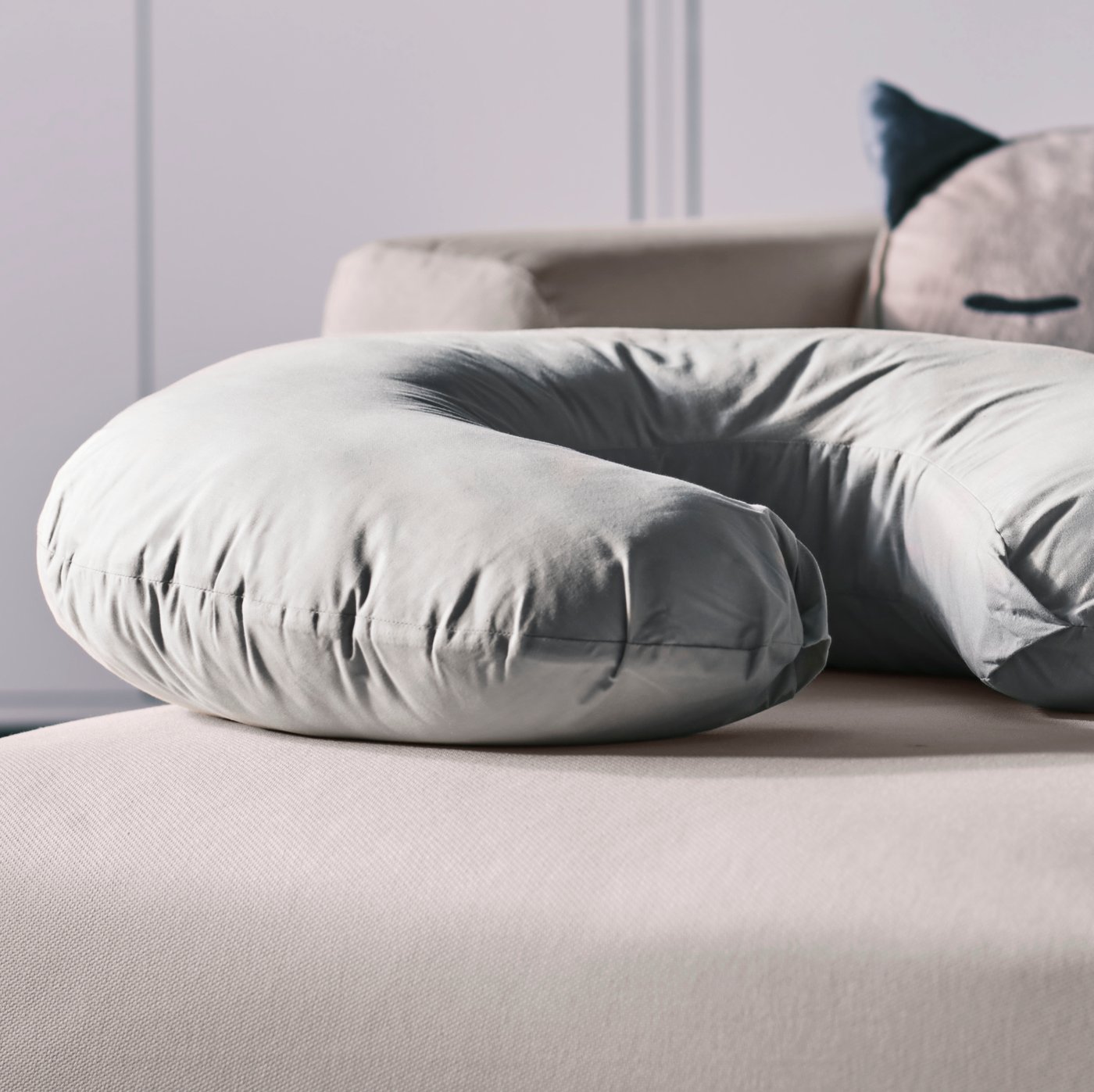 A grey LEN nursing pillow