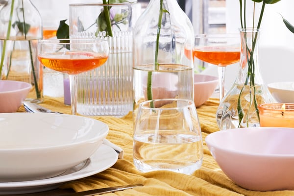 Close-up of water glasses and champagne bowls on a set table