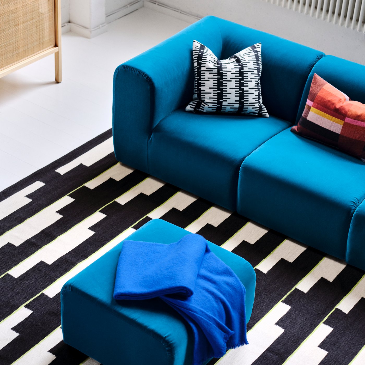 An Alhamn dark turquoise STOCKHOLM 2025 pouffe in the living room