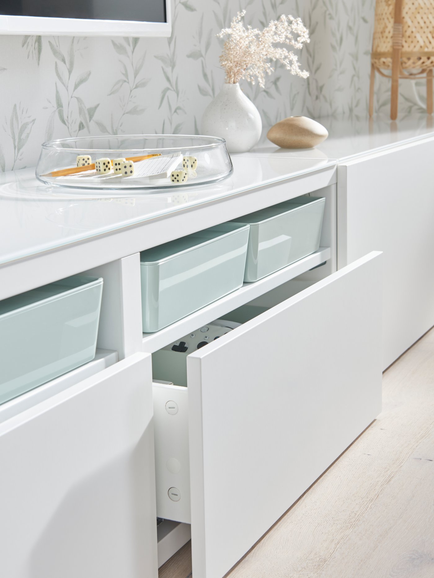 A white BESTÅ cabinet with white LAPPVIKEN drawer fronts in the living room.