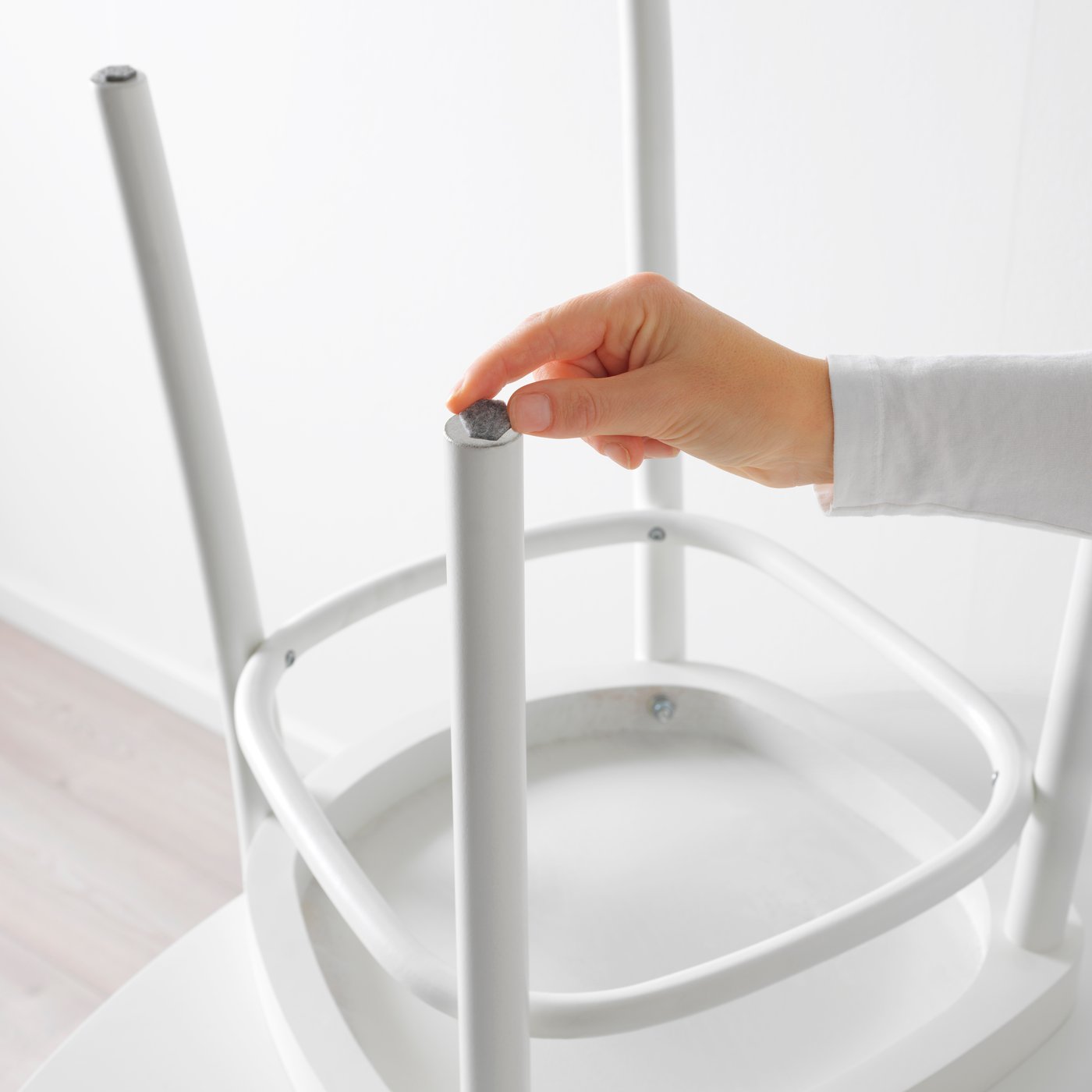 A grey FIXA stick-on floor protectors