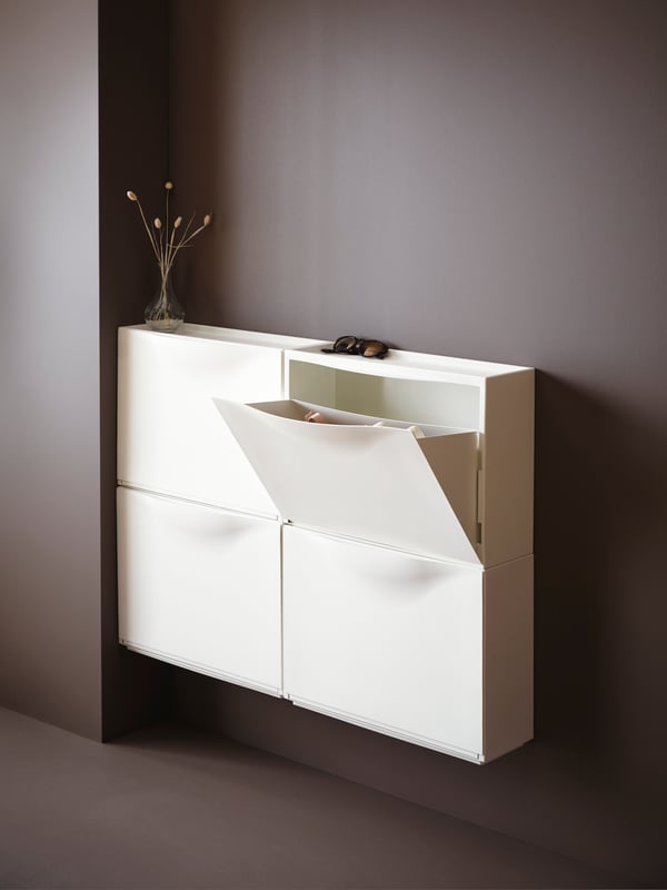 A white TRONES shoe cabinet/storage in the hallway