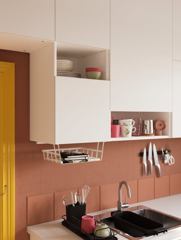 VALLSTENA kitchen fronts create open storage solutions where decorative items, like cups and plates, are put on display.