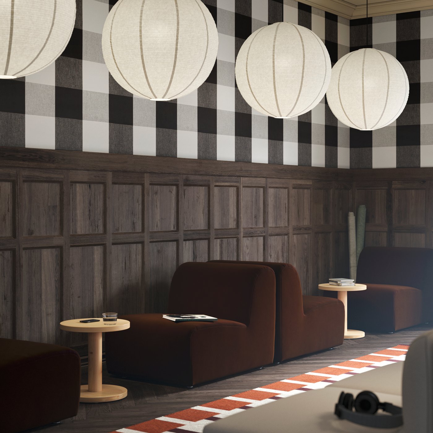 Two dark brown STOCKHOLM seats, paired with pine side tables, with GULLSUDARE pendant lamps hanging from the ceiling.