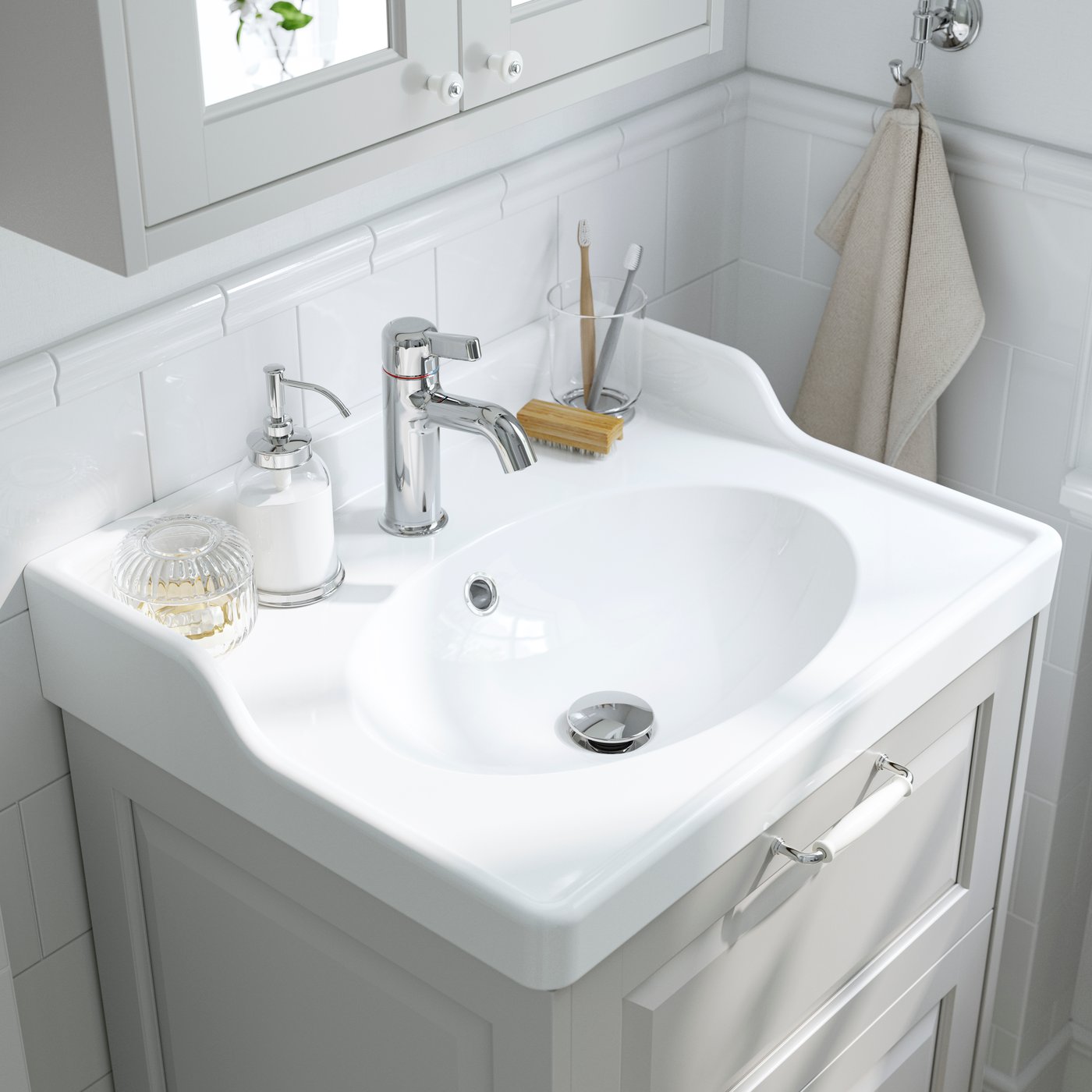 A white RUTSJÖN wash-basin with water trap