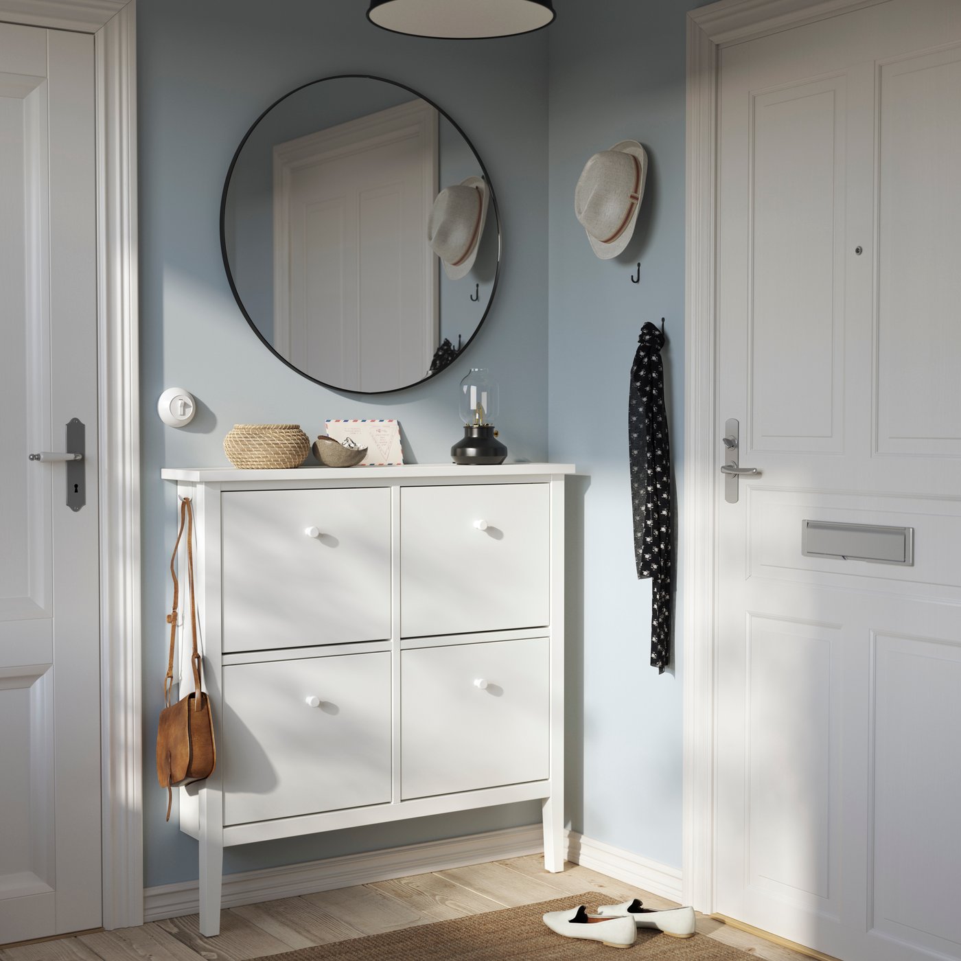 A white GULLABERG shoe cabinet with 4 compartments in the hallway