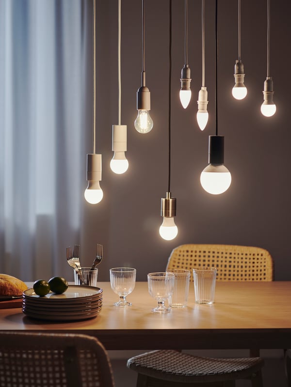 Several SOLHETTA bulbs of different sizes and shapes are hanging from the ceiling.