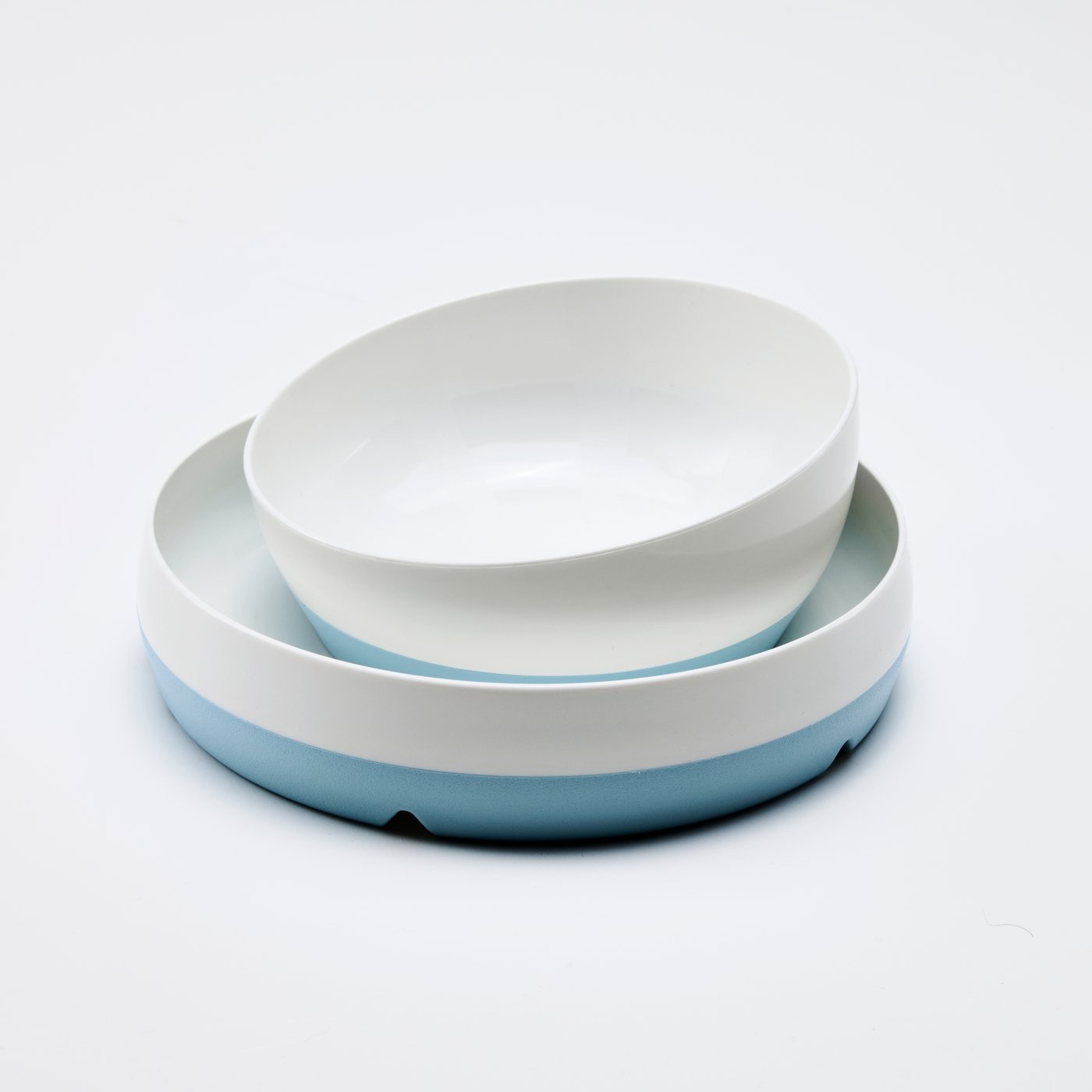 A blue/white BÖRJA plate and bowl sit on a white surface in a completely white environment.