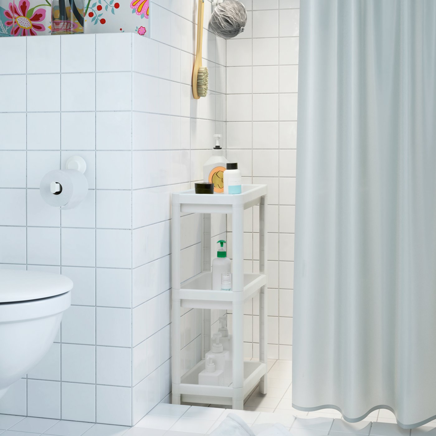 A white VESKEN shelf unit in the bathroom