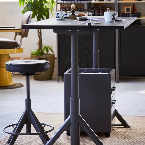 A dark grey IDÅSEN drawer unit on castors in the home office
