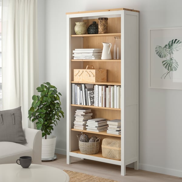 A white stain/light brown HEMNES bookcase in the living room