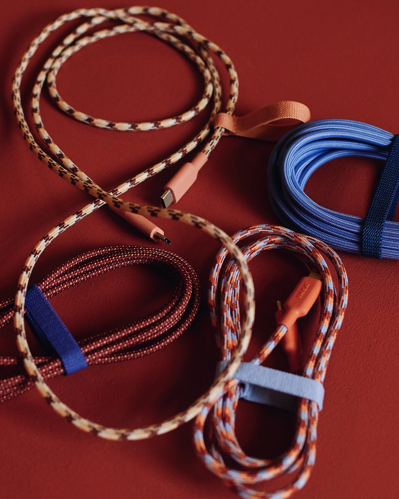 A purple LILLHULT USB-C to USB-C cable against a red surface.