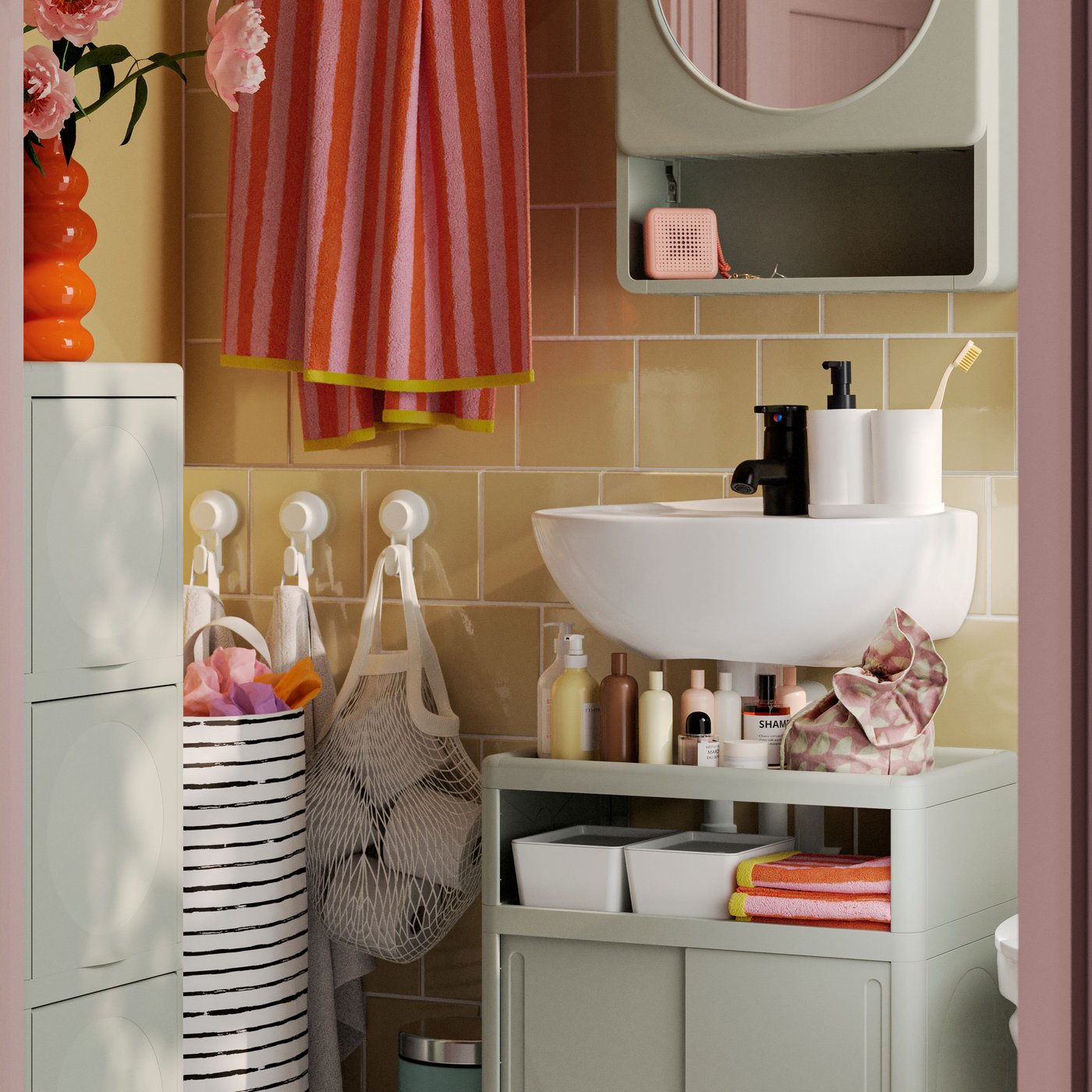 A green IVÖSJÖN cabinet with doors in the bathroom