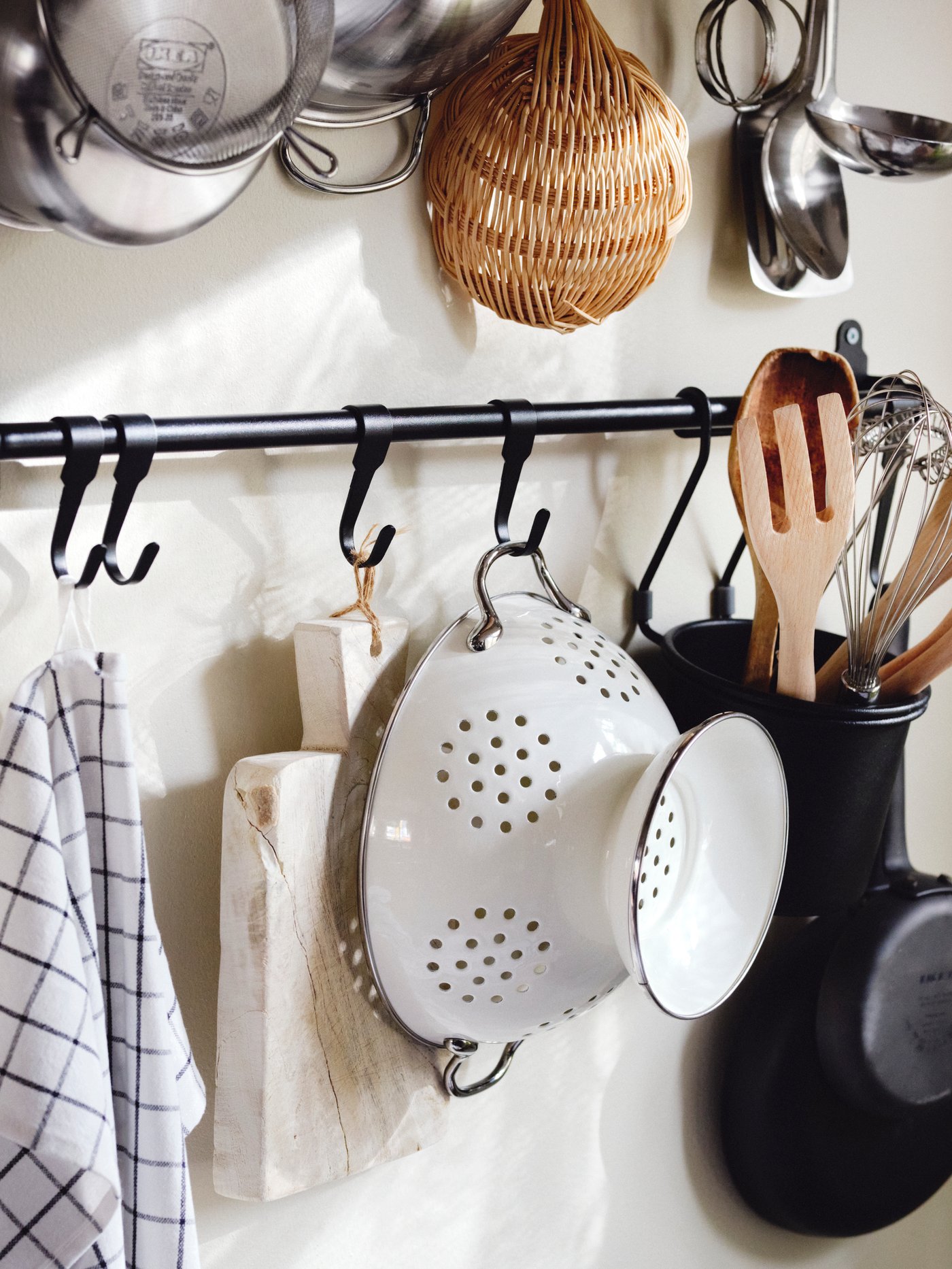 IKEA HULTARP hanging rail in black with a white collander hanging from one of the hooks