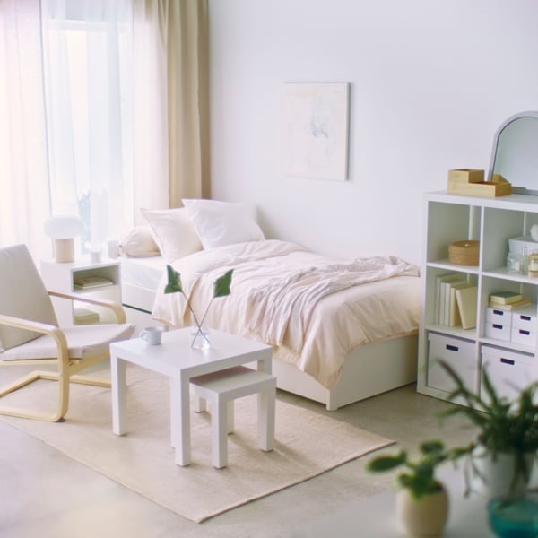 A white LACK side table in the bedroom