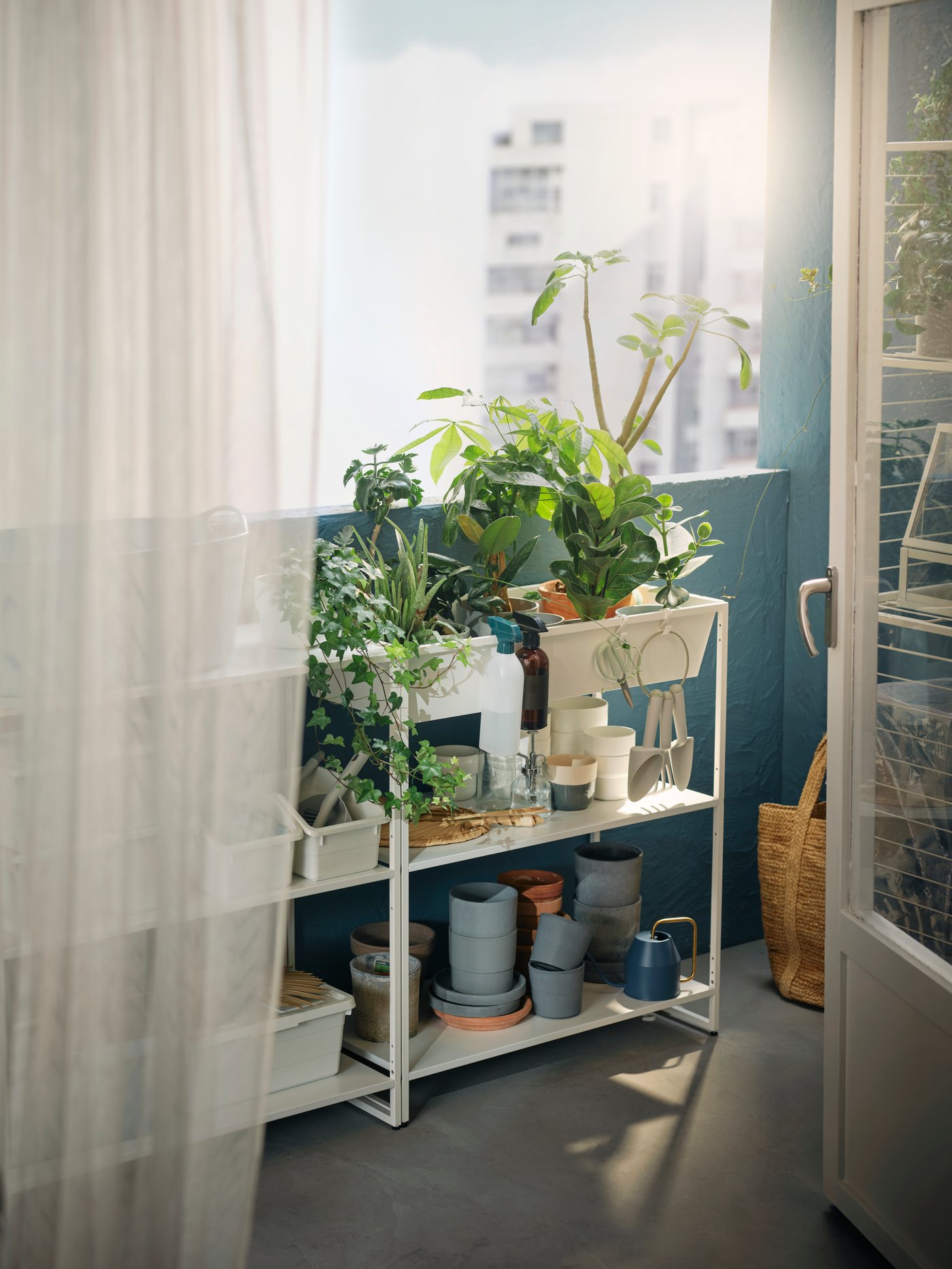 An in/outdoor/metal white JOSTEIN shelving unit with container