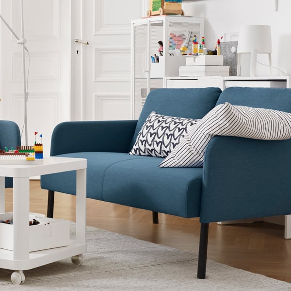 A white/black LYKTFIBBLA cushion in the living room