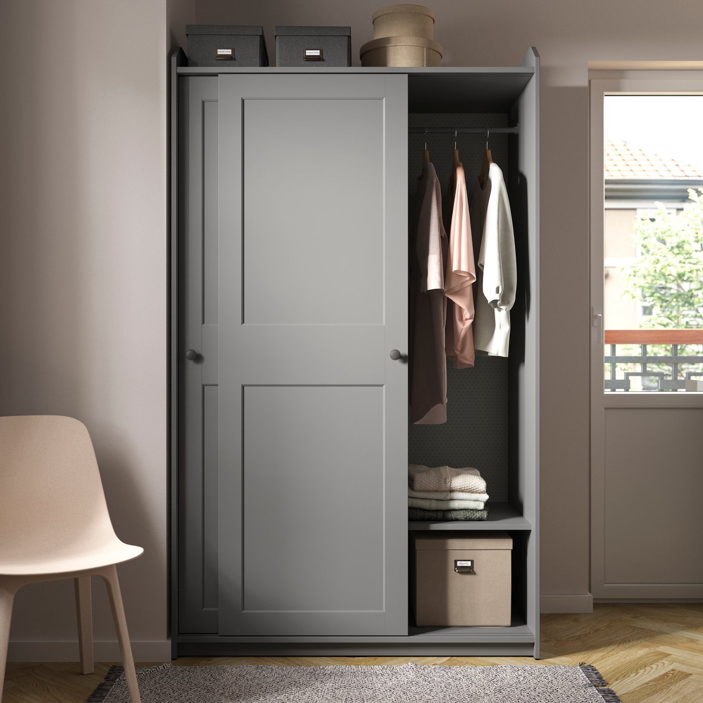 A grey HAUGA wardrobe with sliding doors in the bedroom.