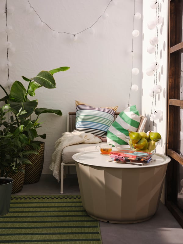 Outdoor chair tucked into the corner of a balcony space.