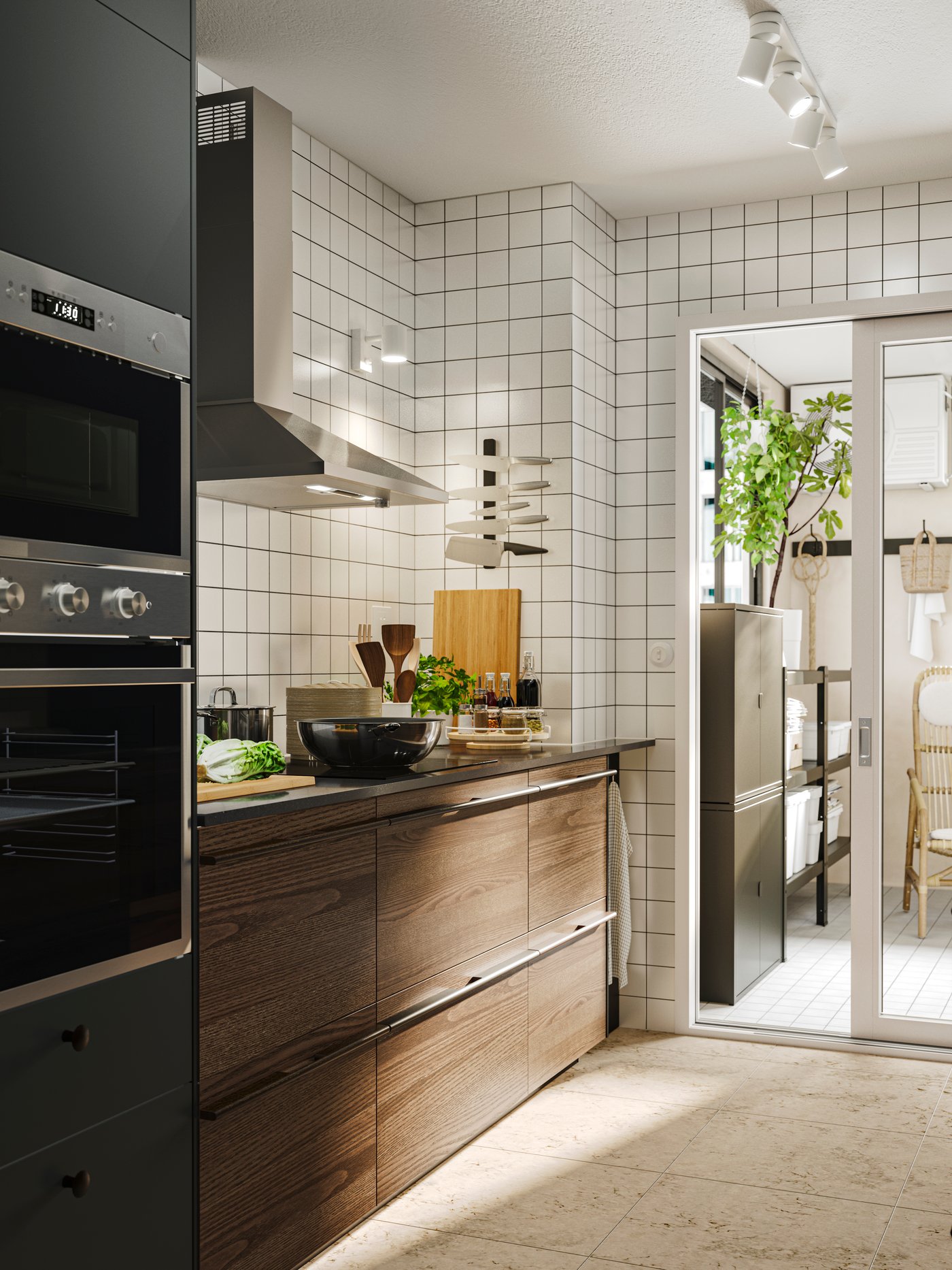 Kitchen with STENSTA dark brown ash veneer fronts, tiled backsplash, and a bright pantry with a lush potted plant.