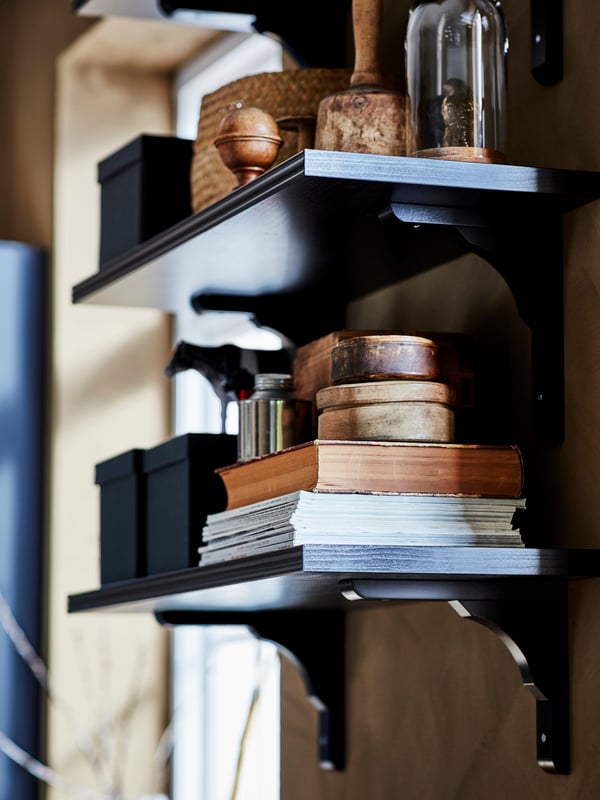 Shelves with brackets, bookz and storage boxes with lids.