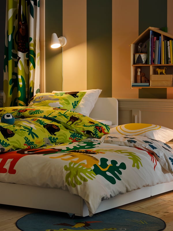 A white FUBBLA LED wall lamp in the childrens room