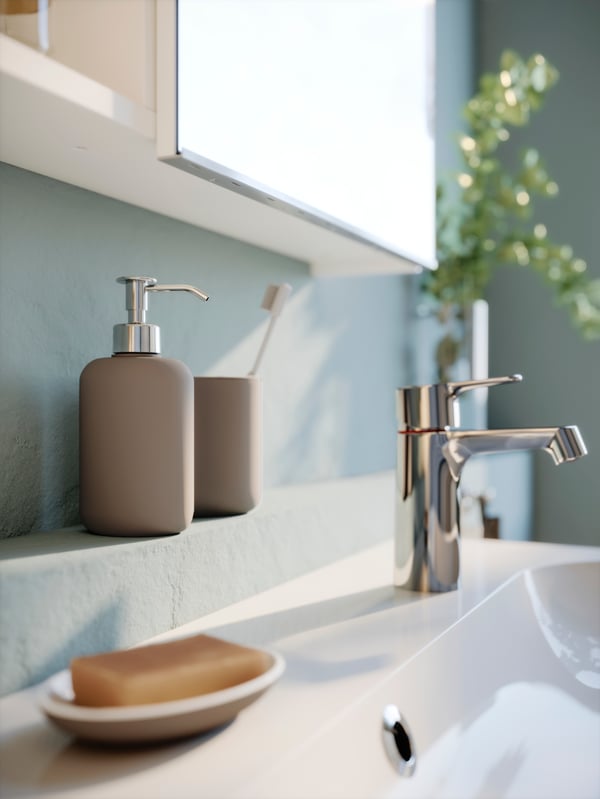 A white STORJORM mirror cab 2 door/built-in lighting in the bathroom