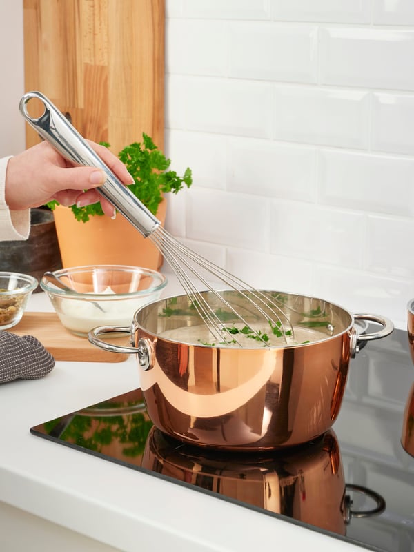 A copper/stainless steel FINMAT pot with lid in the kitchen