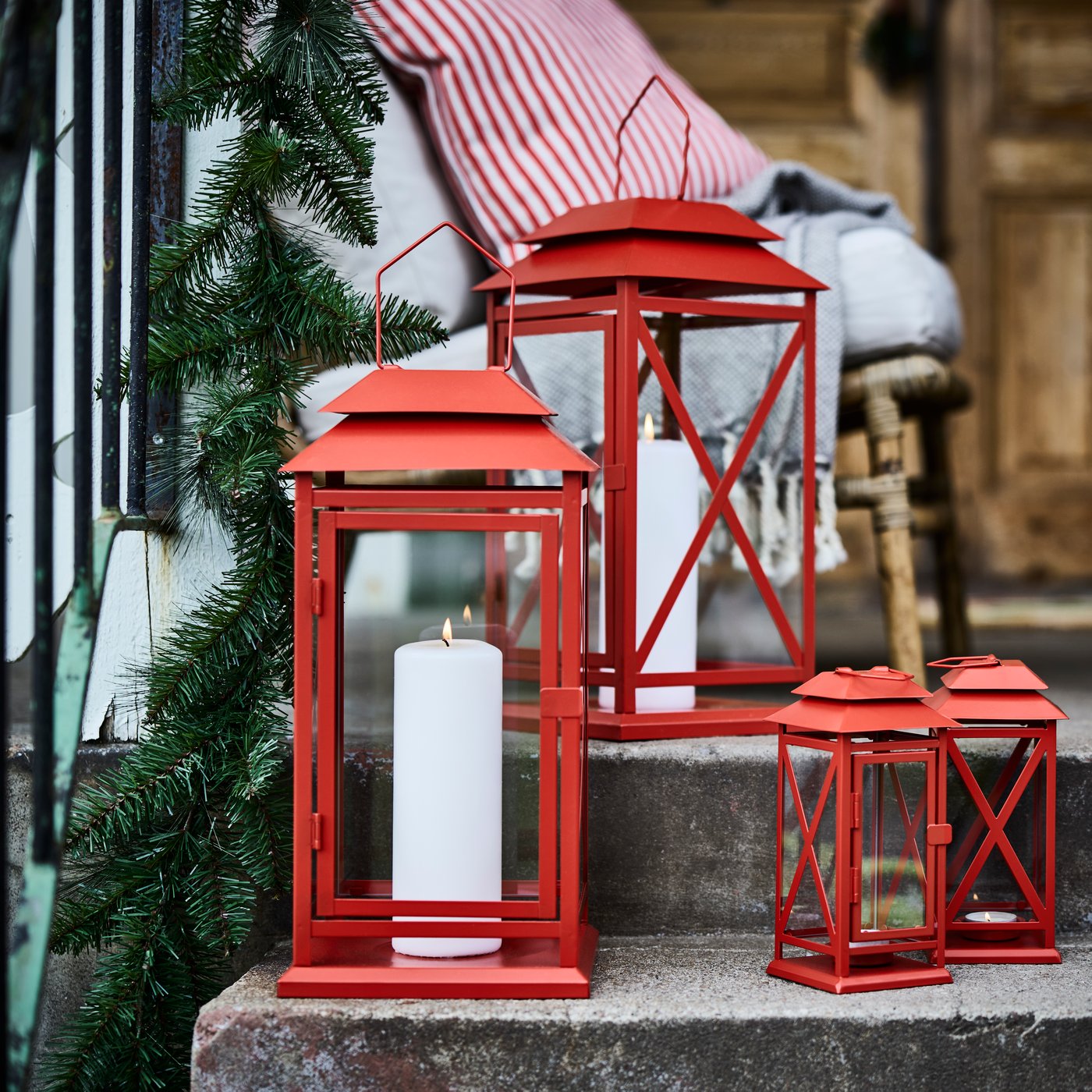 A bright red VINTERFINT lantern for tealight, in/outdoor