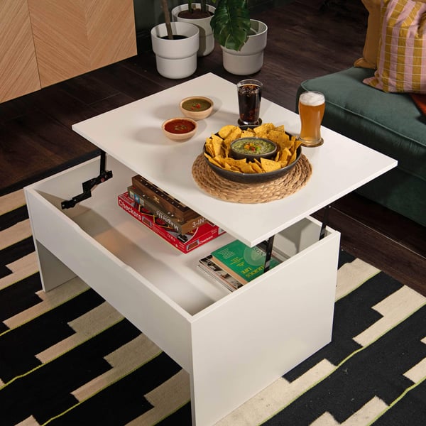 A white ÖSTAVALL adjustable coffee table in the living room