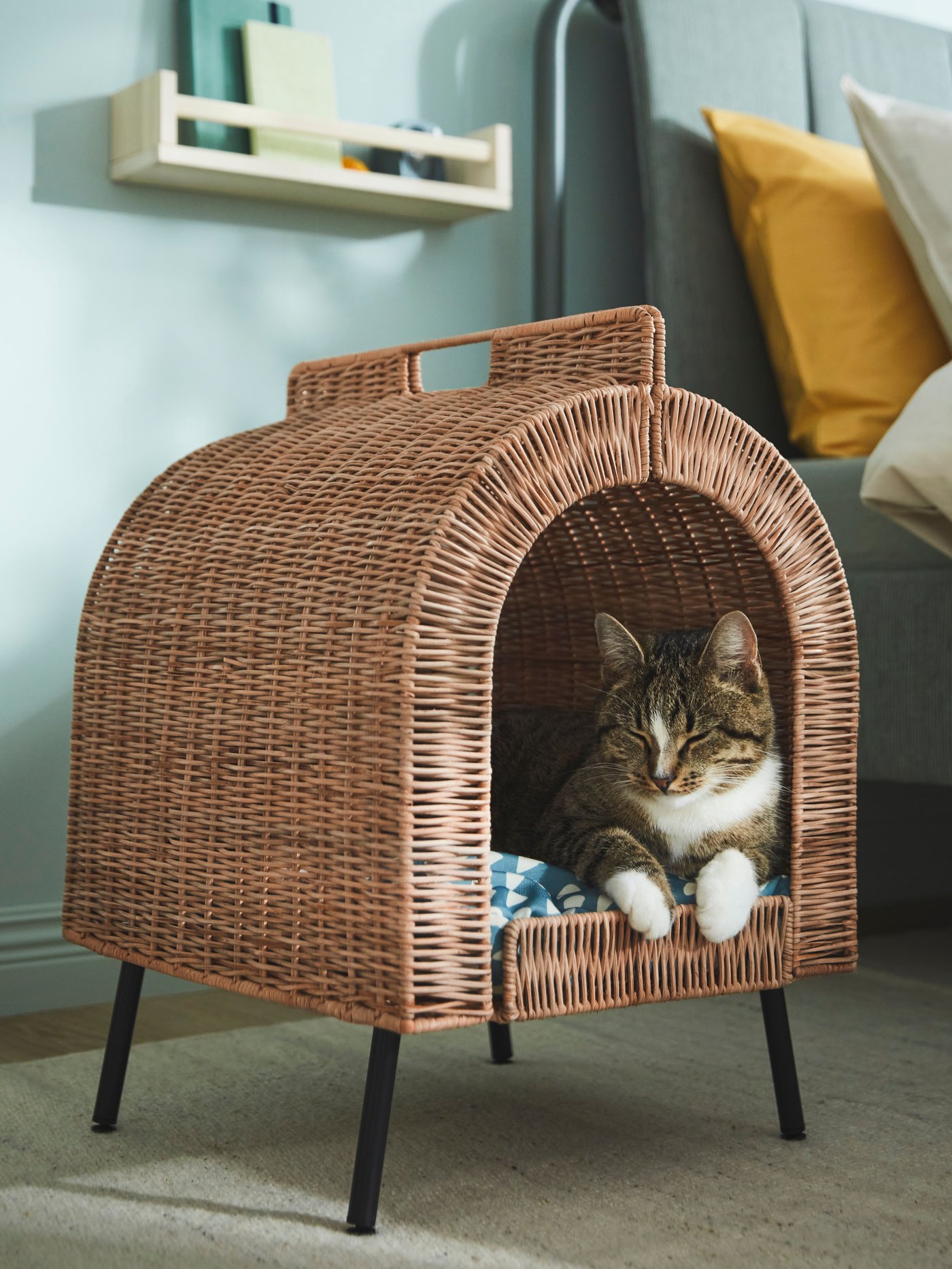 A rattan UTSÅDD cat house on legs in the bedroom