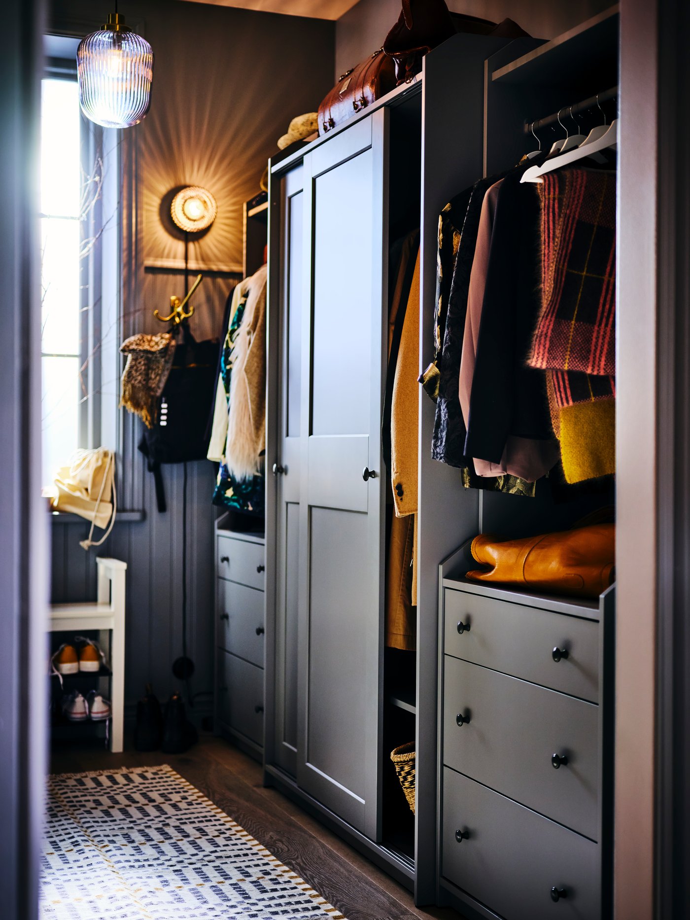 A cozy storage closet with coats and scarves hanging in it