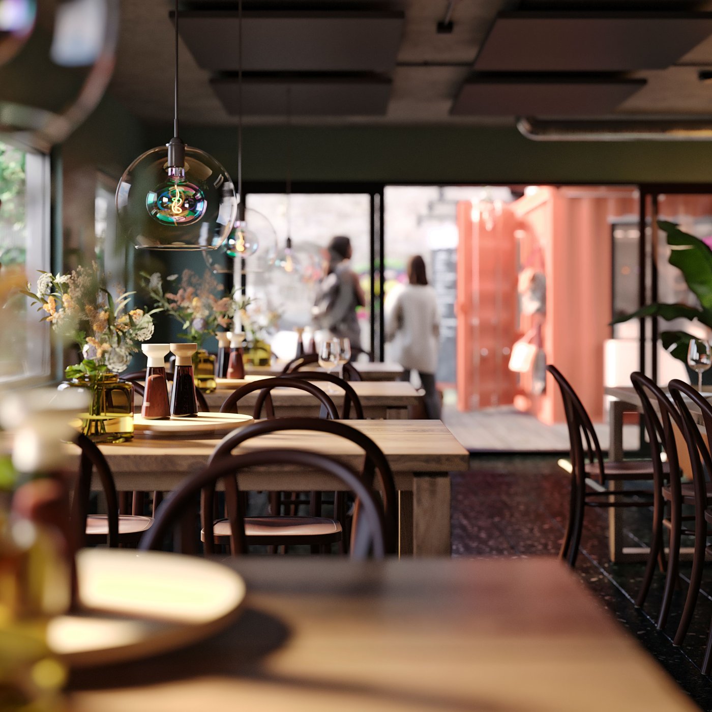 A large open restaurant in mood-setting lighting with brown wooden tables and chairs, and big windows towards the street.