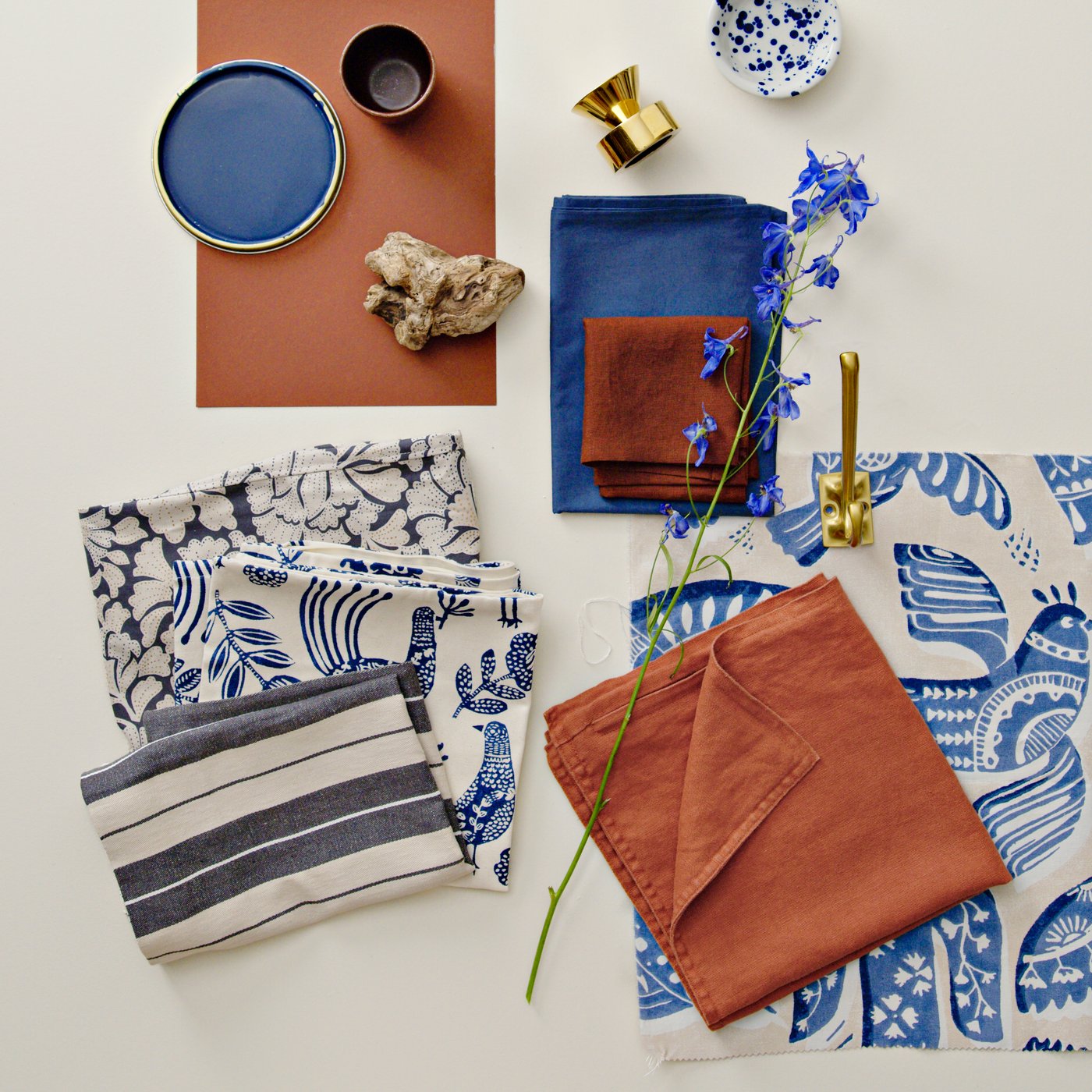 A swatch of BITTERSÖTA pre-cut fabric in beige and blue, displayed alongside various decorative items and textiles.