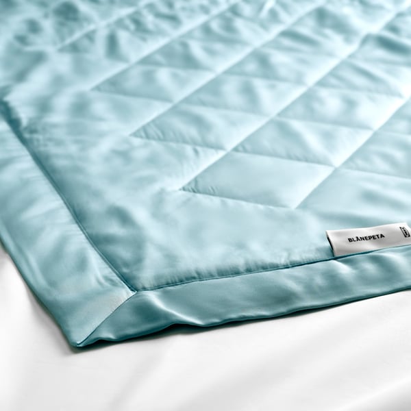 Close-up of BLÅNEPETA mattress protector.