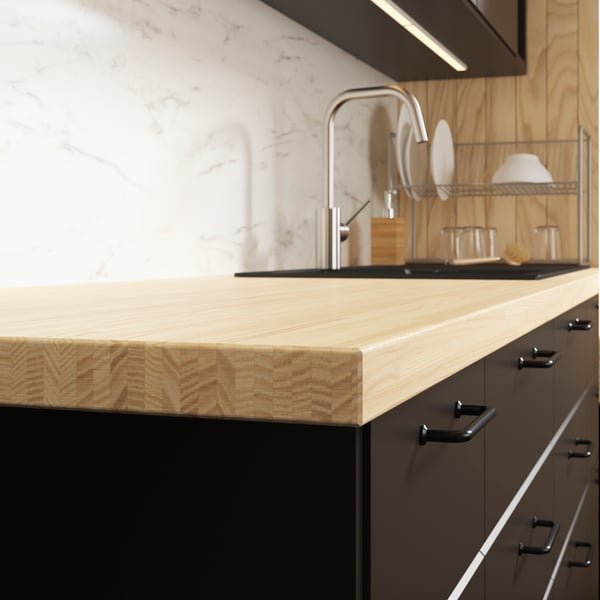 An ash/veneer PINNARP worktop in the kitchen