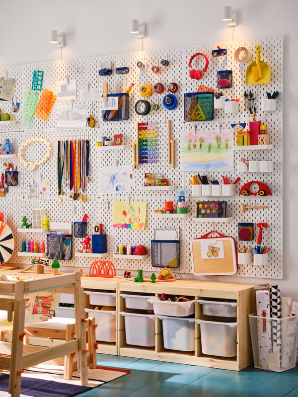 Children's room with TROFAST storage combination with boxes underneath SKÅDIS pegboard with toy storage, craft supplies stored on shelves and hooks