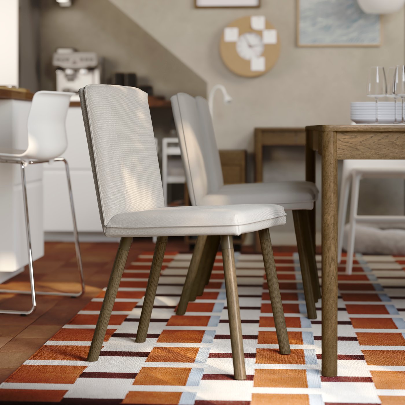 A bright dining room has a TONSTAD extendable table in brown stained oak veneer with several matching chairs around it.