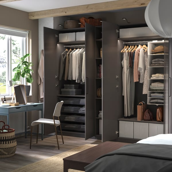 Two PAX wardrobes with dark brown-black fronts in a bedroom.