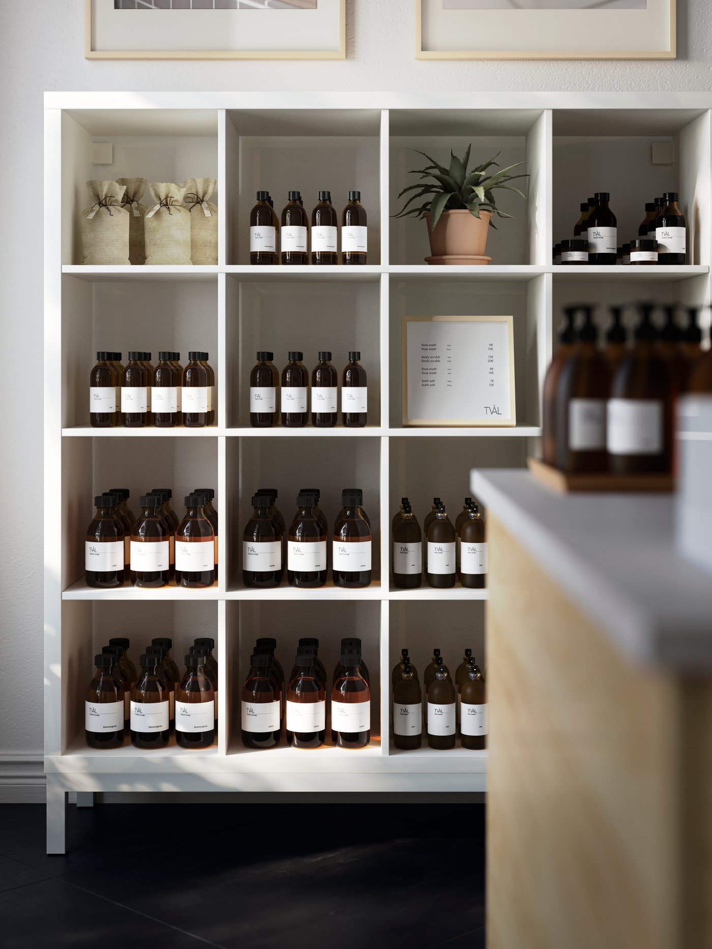 A TOMMARYD table with boxes and bottles on top of it stands in a shop underneath two HEKTAR pendant lamps.
