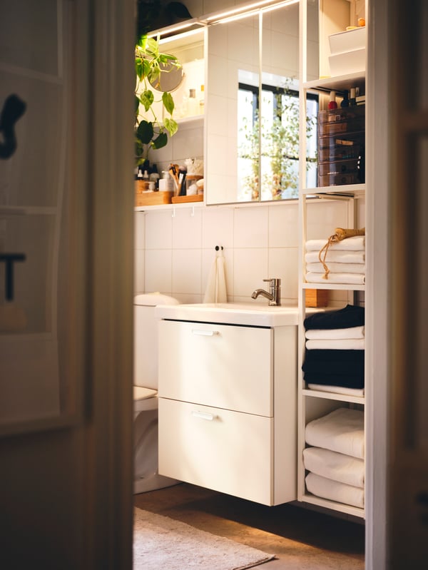 A bathroom with a white ENHET/TVÄLLEN wash-basin below an ENHET mirror cabinet with 2 doors.