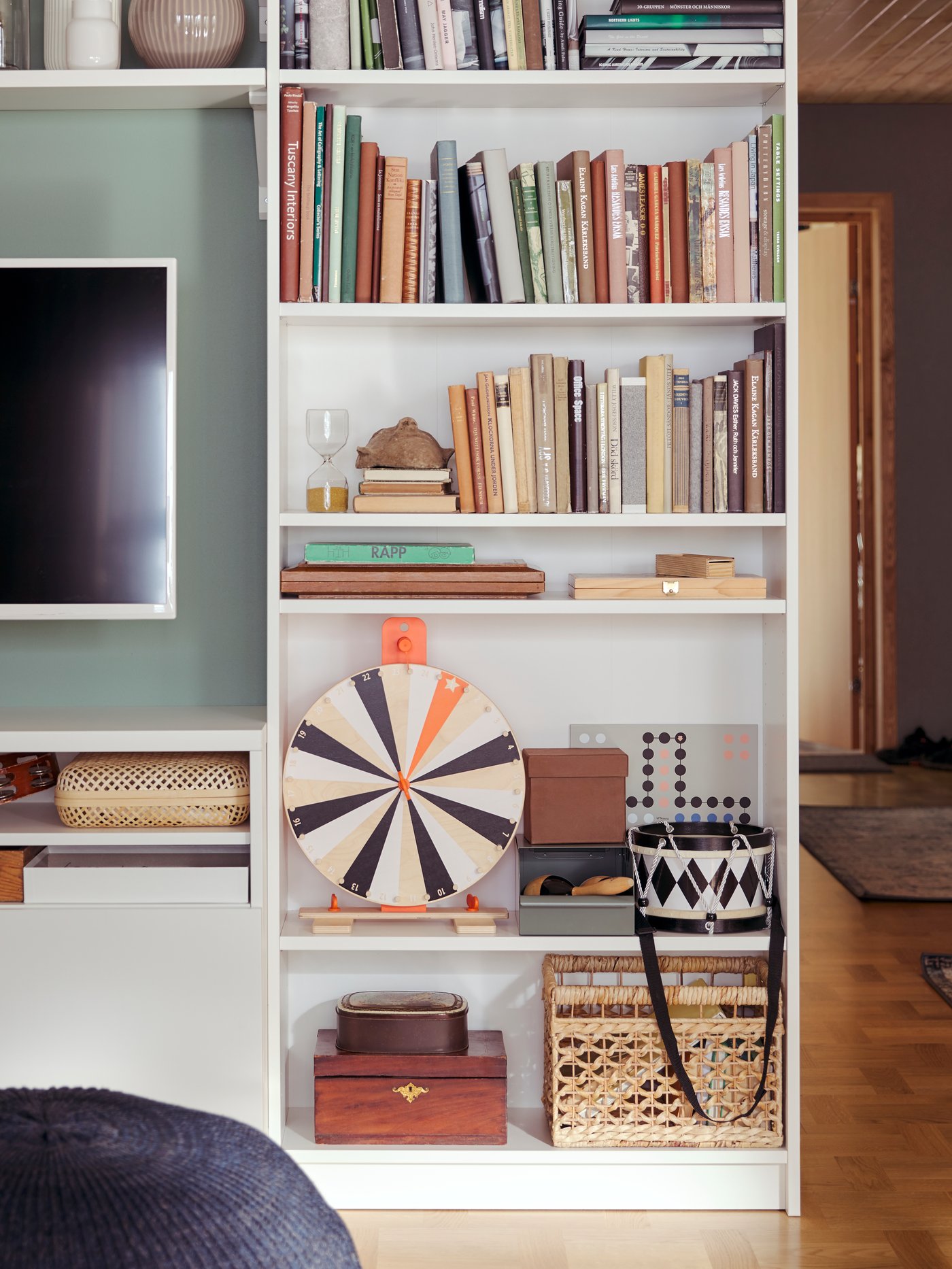 IKEA BILLY shelving unit in white lined up on a wall next to a TV bench.
