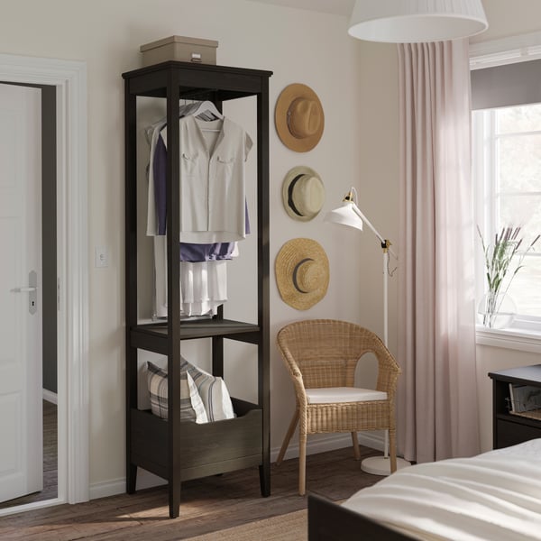 A dark brown stained IDANÄS open wardrobe in the bedroom