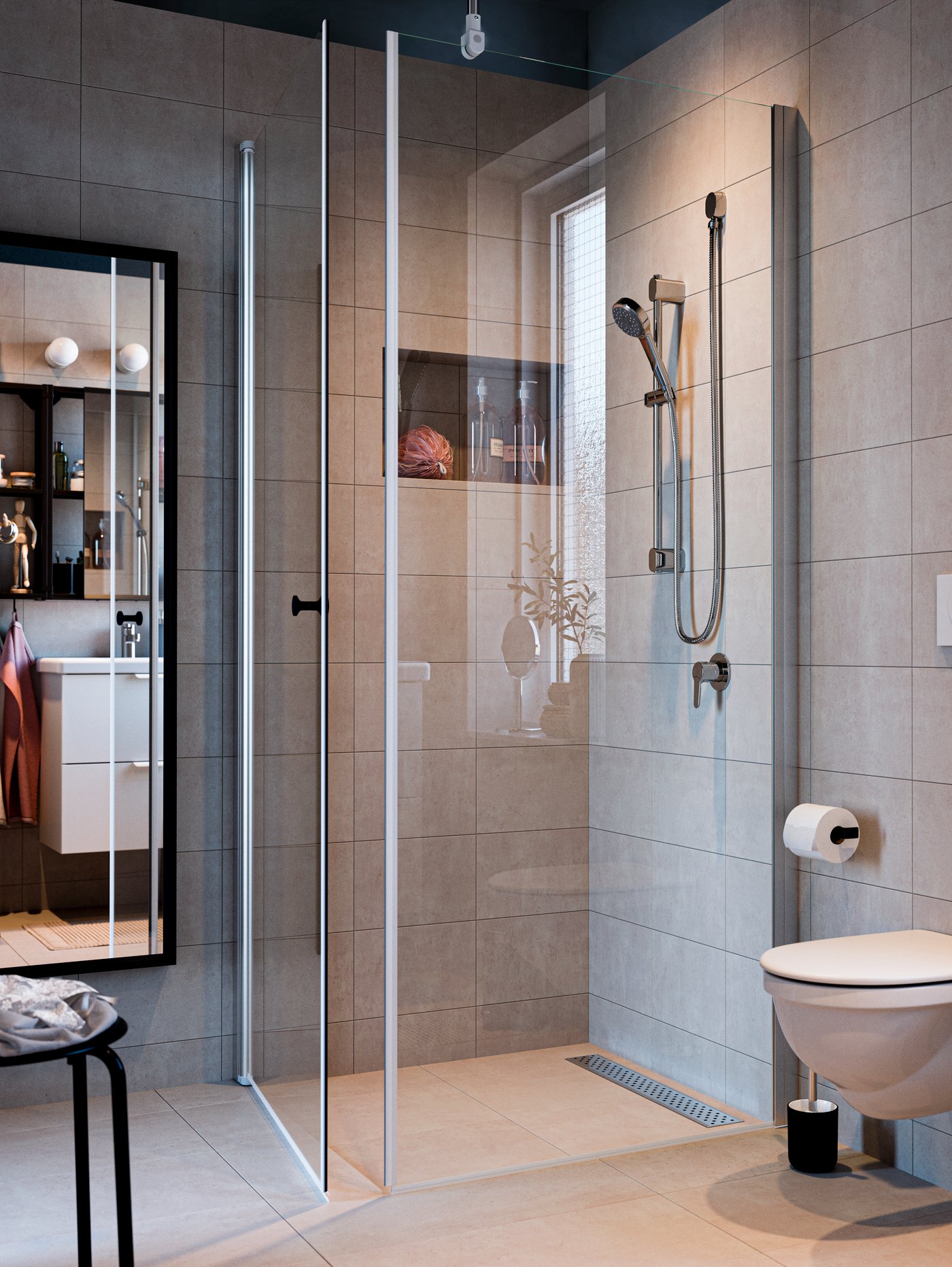 Un baño con paredes de cerámica donde se ve una mampara de baño IKEA con una columna de ducha.