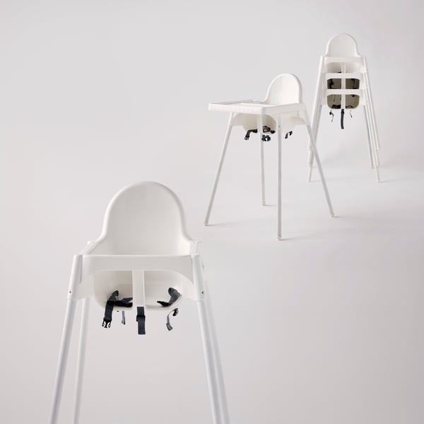 A group of white baby ANTILOP highchairs, some standalone, some stacked.