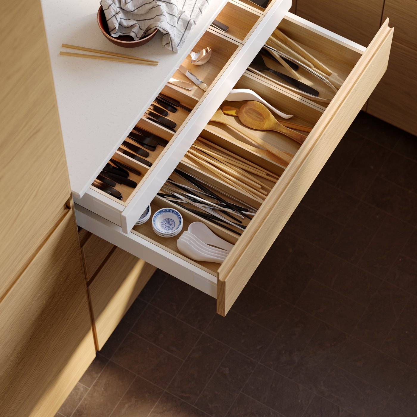 A light bamboo UPPDATERA cutlery tray in the kitchen